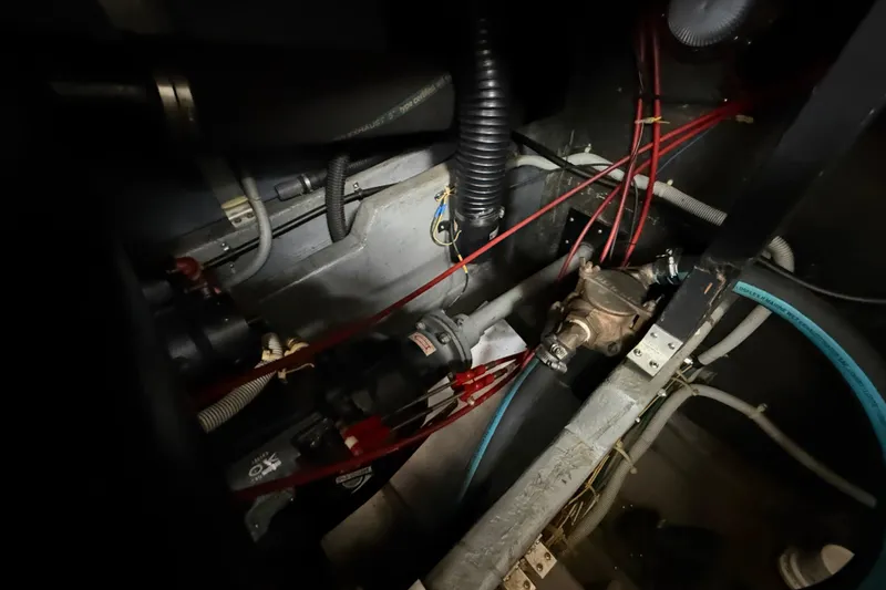 Slide: The Image of Engine room of 1986 Sea Ray 410 Aft Cabin with visible wiring and components. - 85