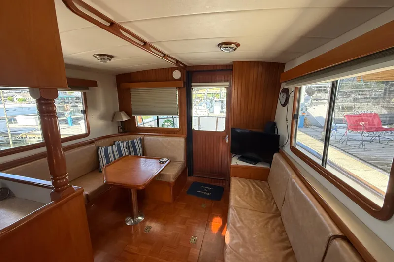 Slide: The Image of Interior of 2001 Kadey-Krogen 39 yacht with cozy seating and wooden finishes. - 11