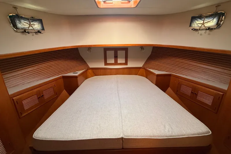 Slide: The Image of Cozy cabin interior of 2001 Kadey-Krogen 39 yacht with wooden accents and soft lighting. - 23