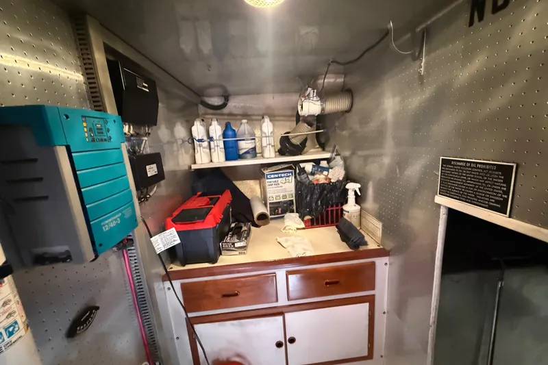 Slide: The Image of Engine room of a 2001 Kadey-Krogen 39 with tools and maintenance supplies. - 27