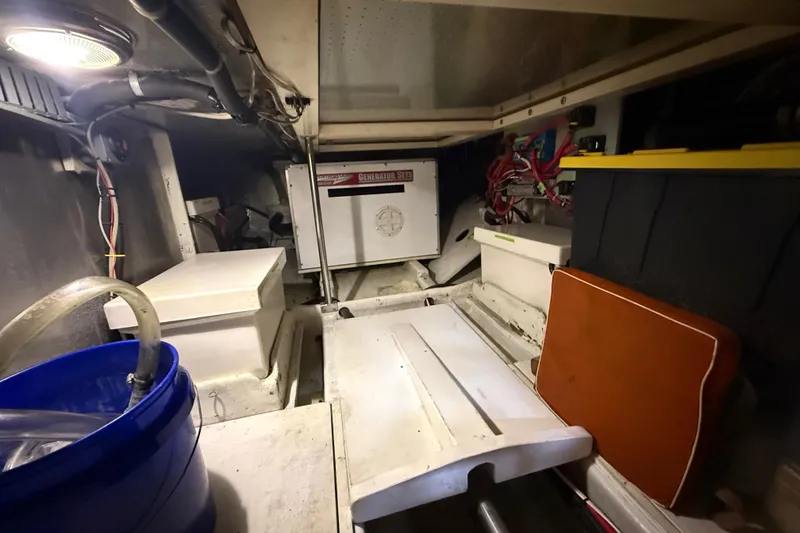 Slide: The Image of Engine room of a 2001 Kadey-Krogen 39 boat, featuring a generator and storage. - 36