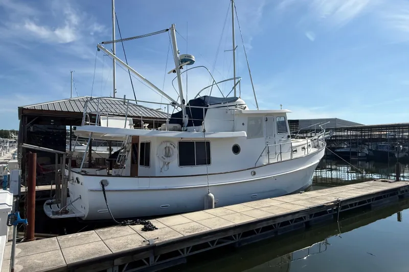 Slide: The Image of 2001 Kadey-Krogen 39 yacht docked at a marina under a clear blue sky. - 5