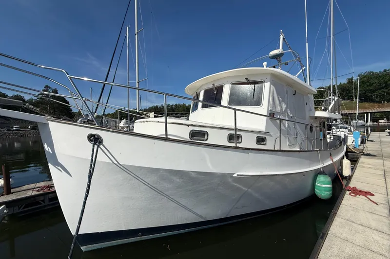 Slide: The Image of 2001 Kadey-Krogen 39 yacht docked at marina under clear blue sky. - 9