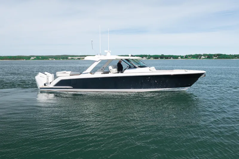 Slide: The Image of 2024 Tiara Yachts 43 LS cruising on calm waters, showcasing sleek design and luxury. - 10