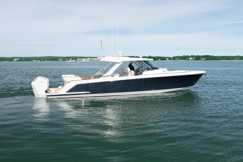 Slide: The Image of 2024 Tiara Yachts 43 LS cruising on calm waters, showcasing sleek design and luxury features. - 11