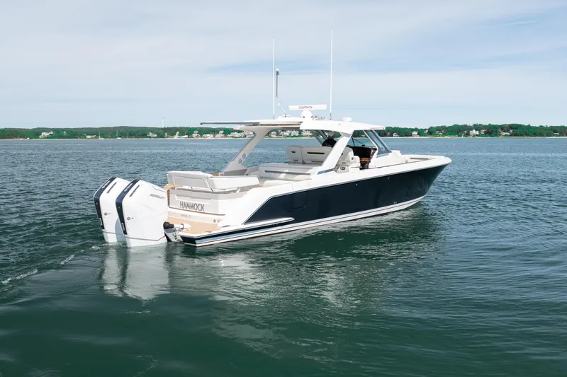 Slide: The Image of 2024 Tiara Yachts 43 LS luxury boat cruising on calm waters. - 14
