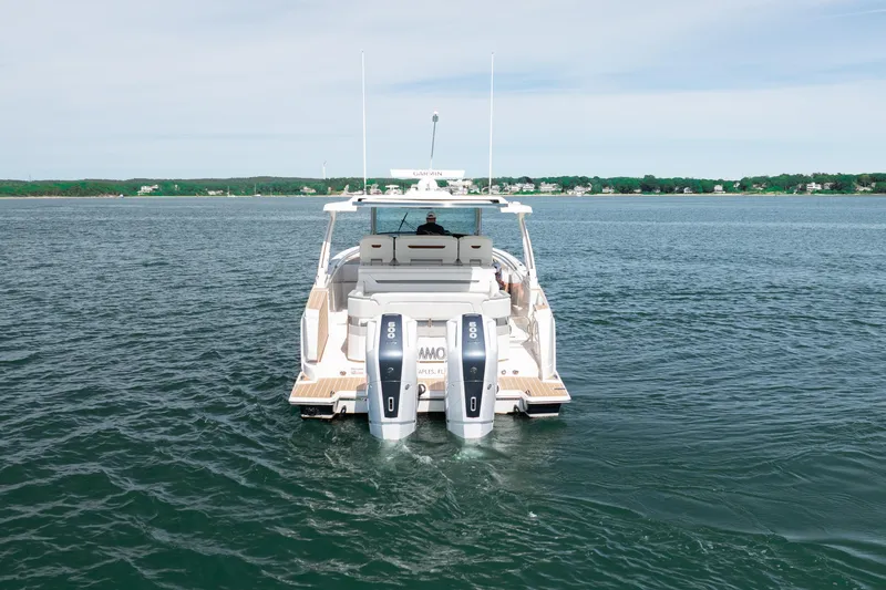 Slide: The Image of 2024 Tiara Yachts 43 LS cruising on calm waters, showcasing twin outboard engines. - 15