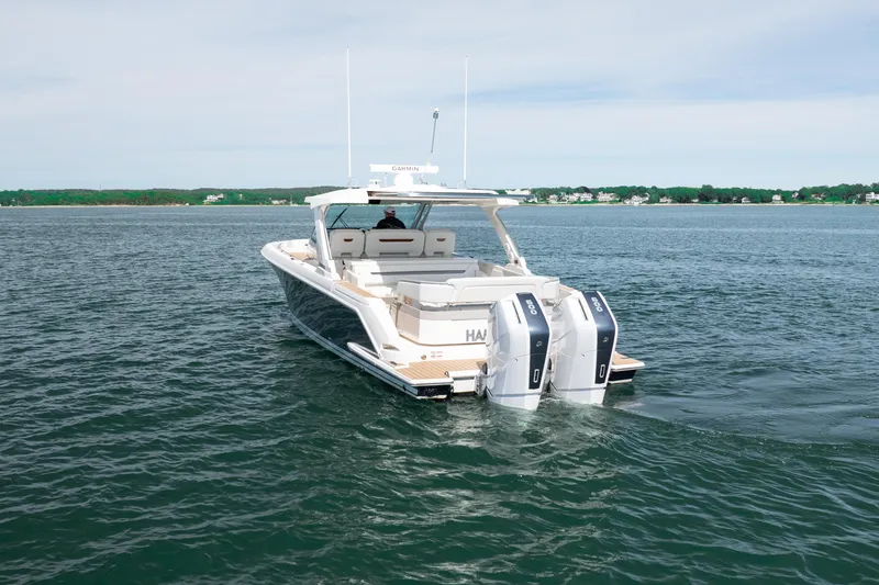 Slide: The Image of 2024 Tiara Yachts 43 LS cruising on open water with twin outboard engines. - 17