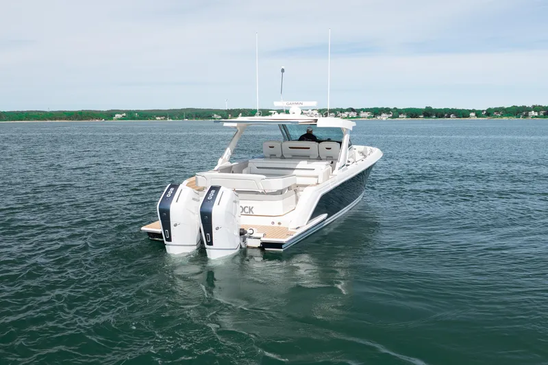 Slide: The Image of 2024 Tiara Yachts 43 LS cruising on open water, showcasing sleek design and powerful engines. - 18