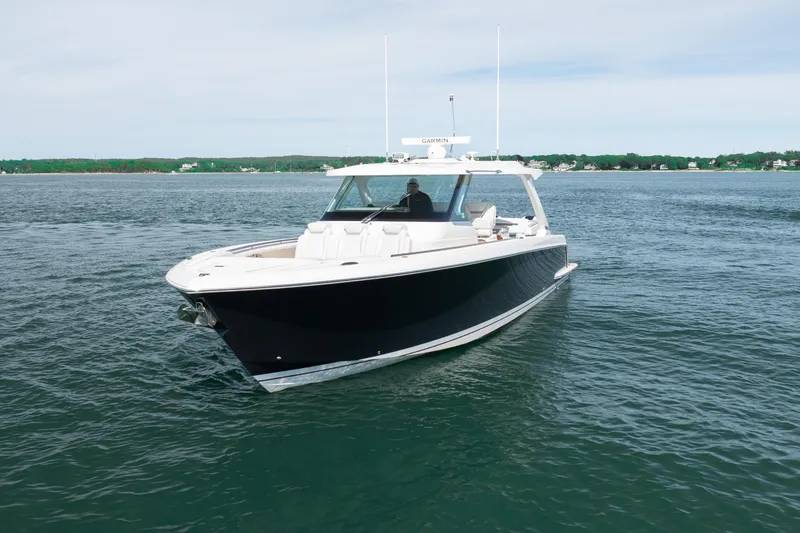 Slide: The Image of 2024 Tiara Yachts 43 LS cruising on calm waters, showcasing sleek design and luxury features. - 2