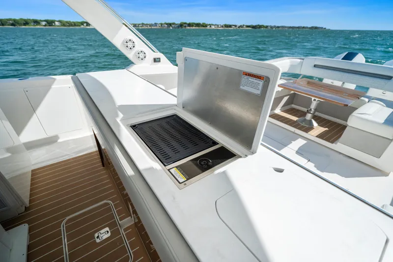 Slide: The Image of 2024 Tiara Yachts 43 LS yacht deck with grill and seating area. - 26