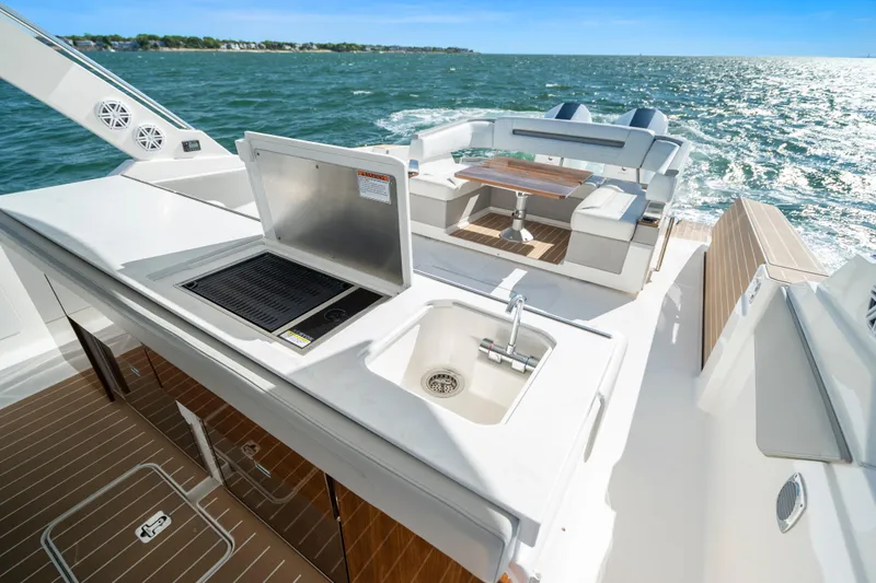 Slide: The Image of 2024 Tiara Yachts 43 LS luxury yacht deck with sink and seating area. - 27