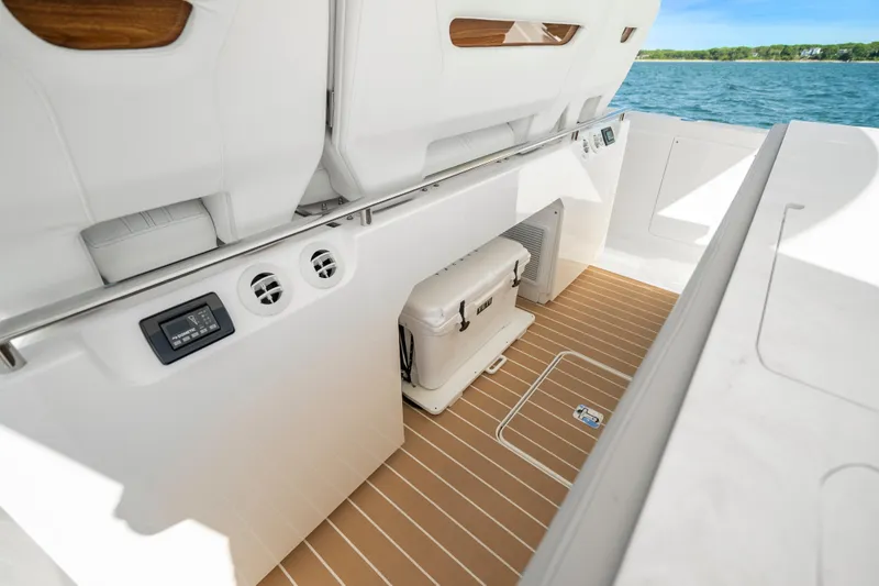 Slide: The Image of 2024 Tiara Yachts 43 LS interior with storage and seating, featuring sleek design and ocean view. - 28