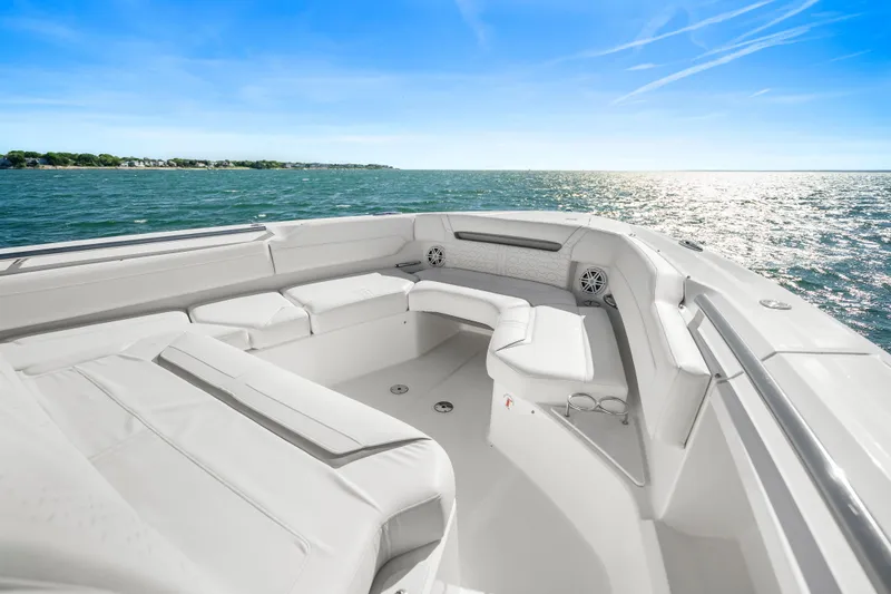 Slide: The Image of Luxurious seating area on the 2024 Tiara Yachts 43 LS, overlooking serene ocean waters. - 34