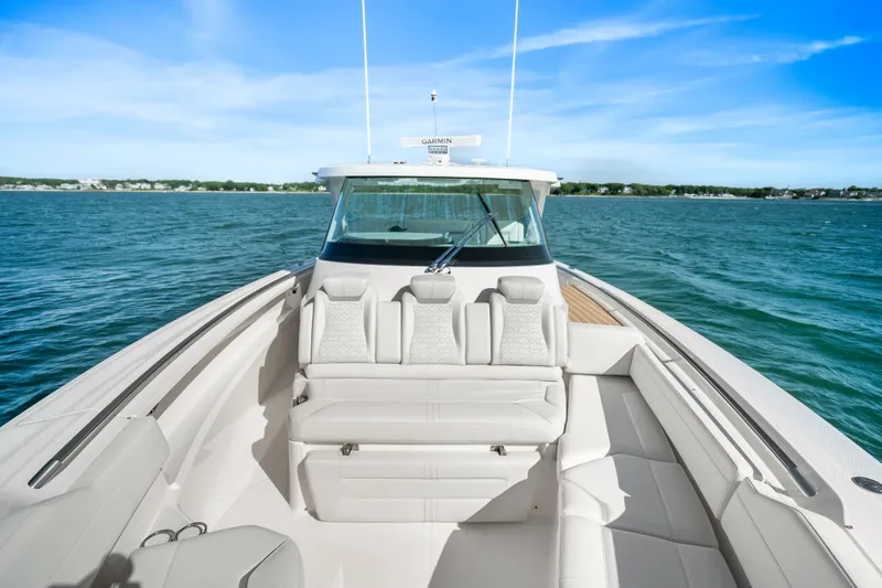 Slide: The Image of 2024 Tiara Yachts 43 LS on open water, showcasing luxurious seating and sleek design. - 36