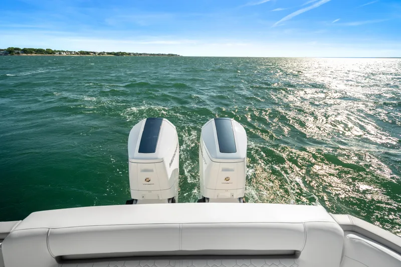 Slide: The Image of 2024 Tiara Yachts 43 LS with twin outboard engines cruising on open water. - 37