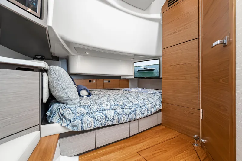 Slide: The Image of Luxurious 2024 Tiara Yachts 43 LS cabin interior with modern design and cozy bedding. - 38