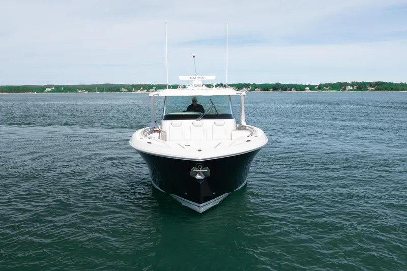 Slide: The Image of 2024 Tiara Yachts 43 LS cruising on calm waters, front view. - 4