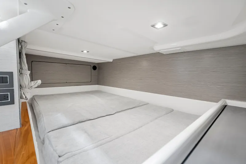 Slide: The Image of 2024 Tiara Yachts 43 LS cabin interior with modern design and cozy bedding. - 40