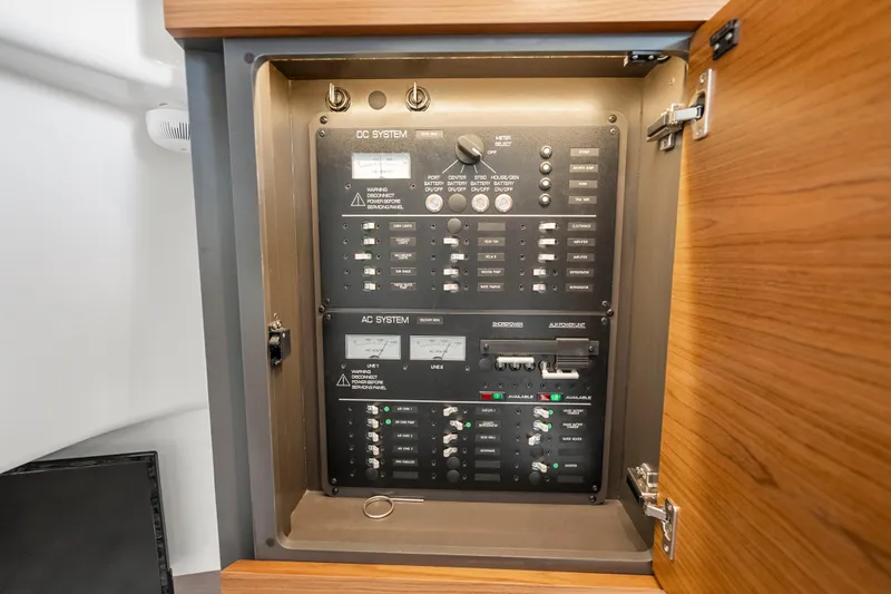 Slide: The Image of Electrical control panel inside 2024 Tiara Yachts 43 LS, showcasing DC and AC systems. - 42
