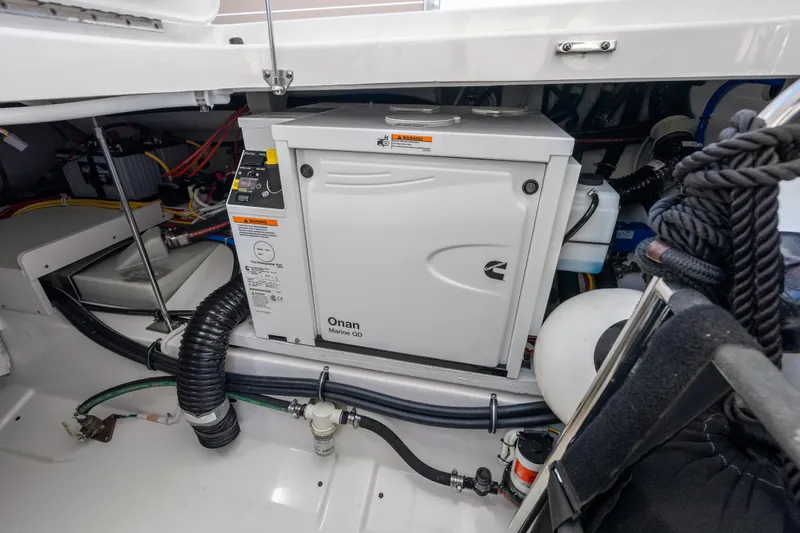 Slide: The Image of Engine compartment of 2024 Tiara Yachts 43 LS featuring Onan Marine generator. - 43