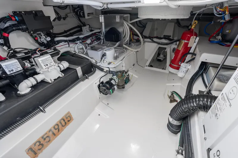 Slide: The Image of Engine room of 2024 Tiara Yachts 43 LS, showcasing mechanical systems and fire extinguisher. - 44