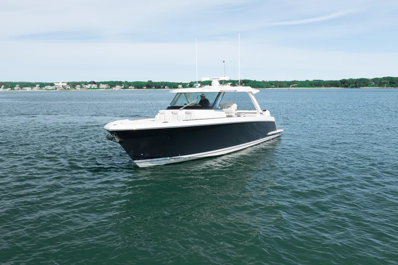 Slide: The Image of 2024 Tiara Yachts 43 LS cruising on calm waters under a clear sky. - 45