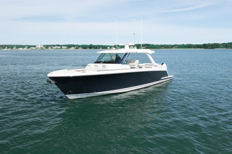 Slide: The Image of 2024 Tiara Yachts 43 LS luxury boat cruising on serene waters. - 46