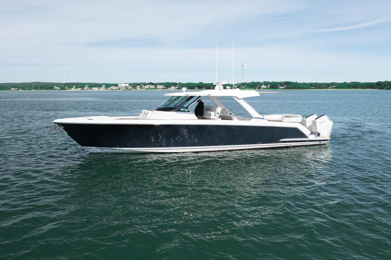 Slide: The Image of 2024 Tiara Yachts 43 LS luxury boat cruising on calm waters. - 48