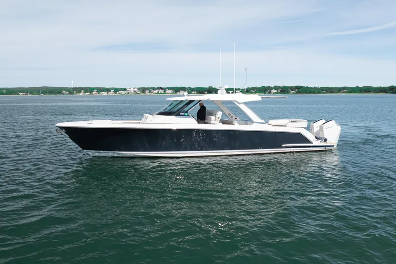 Slide: The Image of 2024 Tiara Yachts 43 LS luxury boat cruising on calm waters. - 49