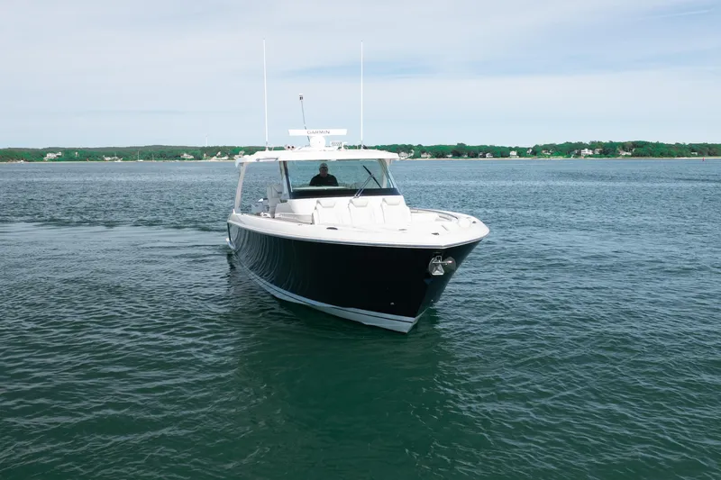 Slide: The Image of 2024 Tiara Yachts 43 LS cruising on calm waters under a clear sky. - 5