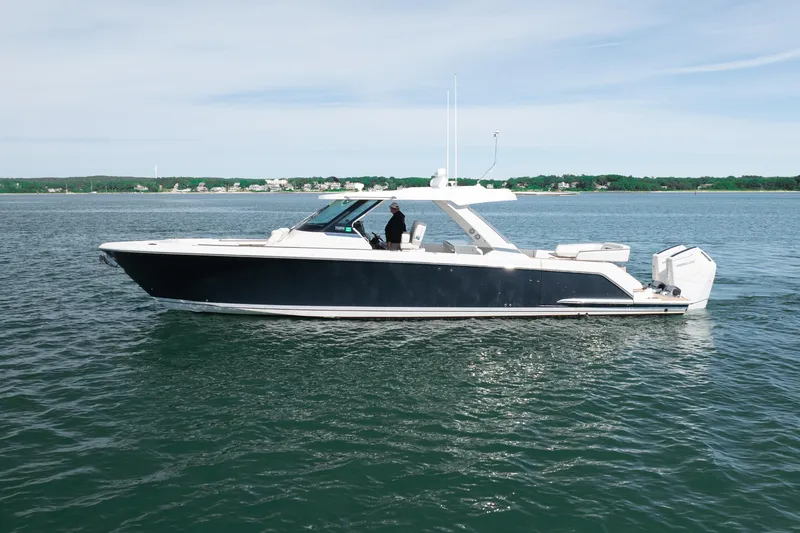 Slide: The Image of 2024 Tiara Yachts 43 LS cruising on calm waters, showcasing sleek design and luxury features. - 51