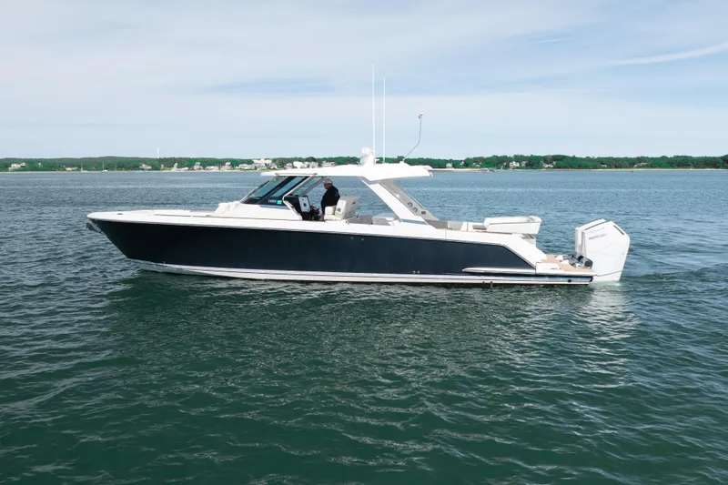 Slide: The Image of 2024 Tiara Yachts 43 LS cruising on calm waters under a clear sky. - 52