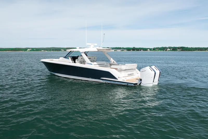 Slide: The Image of 2024 Tiara Yachts 43 LS luxury boat on open water, featuring sleek design and powerful engines. - 53