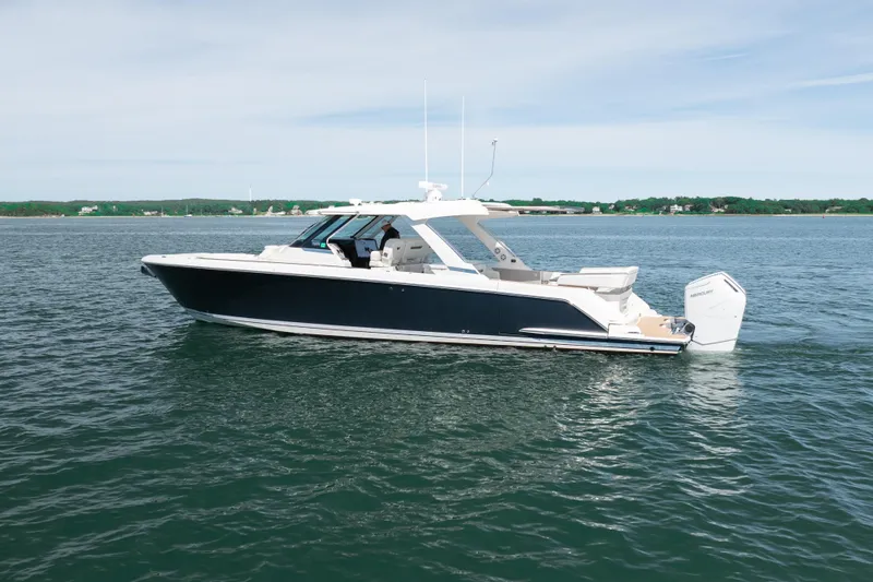 Slide: The Image of 2024 Tiara Yachts 43 LS cruising on calm waters under a clear sky. - 54