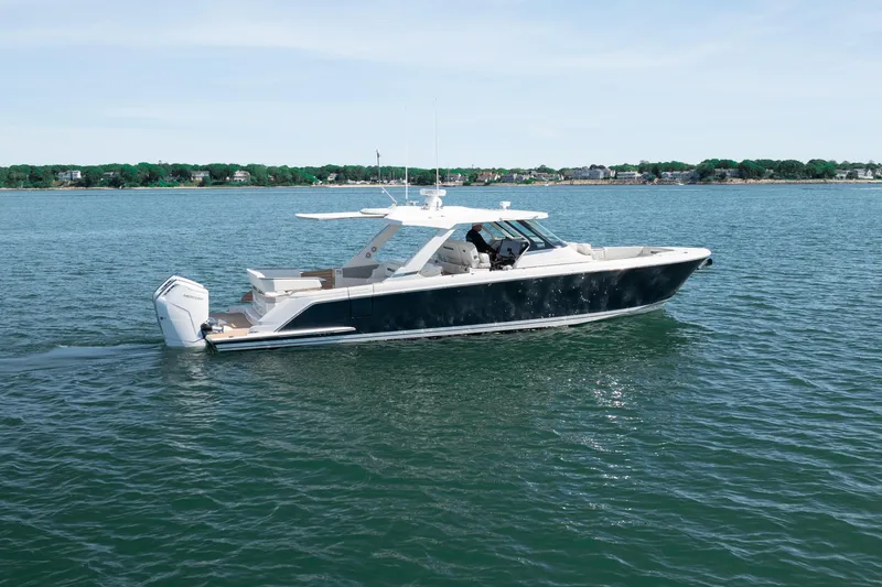Slide: The Image of 2024 Tiara Yachts 43 LS cruising on calm waters, showcasing sleek design and luxury features. - 55