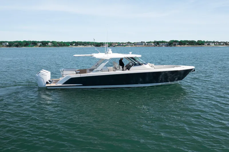 Slide: The Image of 2024 Tiara Yachts 43 LS cruising on calm waters, showcasing sleek design and luxury features. - 56