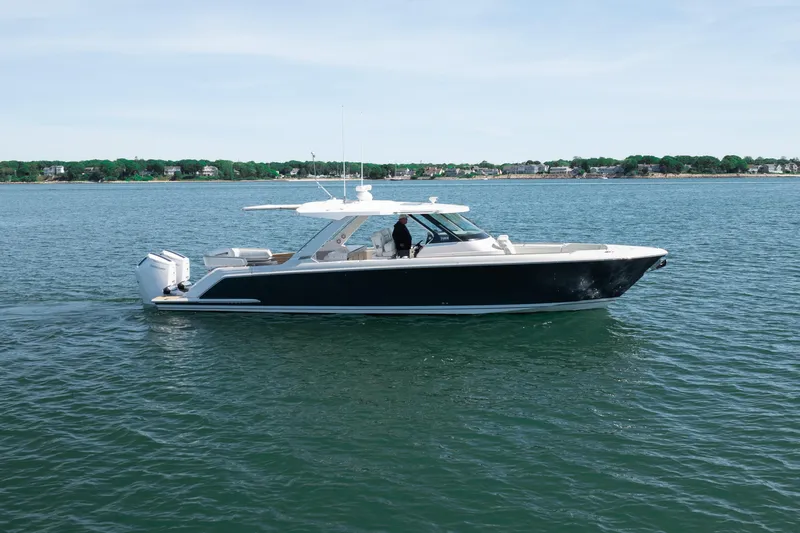 Slide: The Image of 2024 Tiara Yachts 43 LS cruising on calm waters, showcasing sleek design and luxury features. - 57