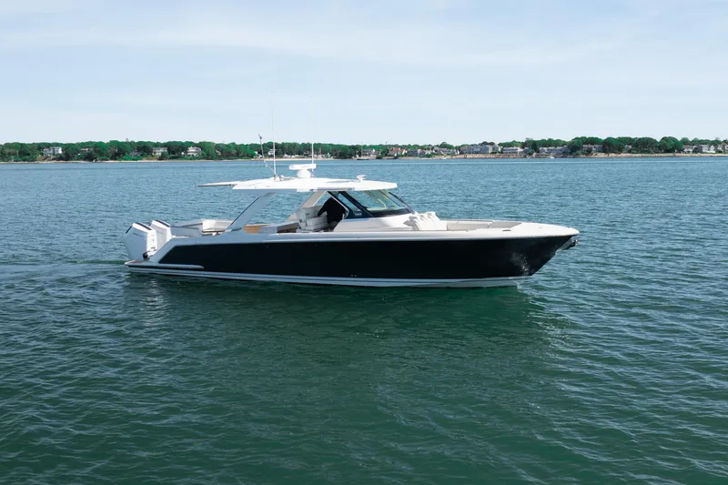 Slide: The Image of 2024 Tiara Yachts 43 LS cruising on calm waters, showcasing sleek design and luxury features. - 58