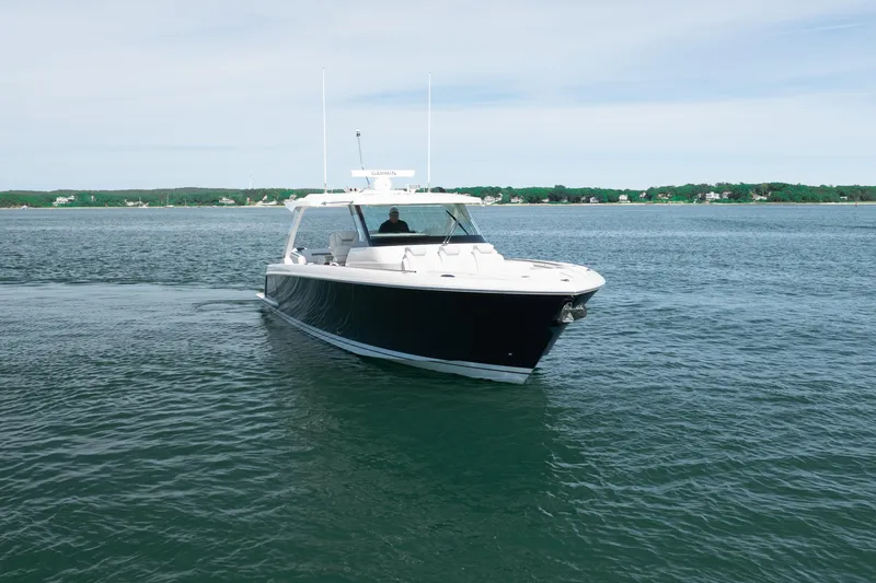 Slide: The Image of 2024 Tiara Yachts 43 LS cruising on calm waters, showcasing sleek design and luxury. - 6