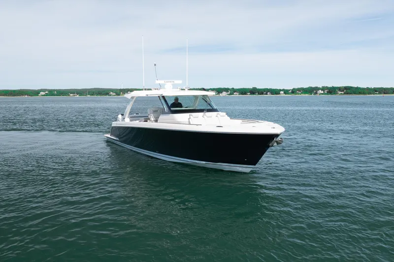 Slide: The Image of 2024 Tiara Yachts 43 LS cruising on calm waters under a clear sky. - 7