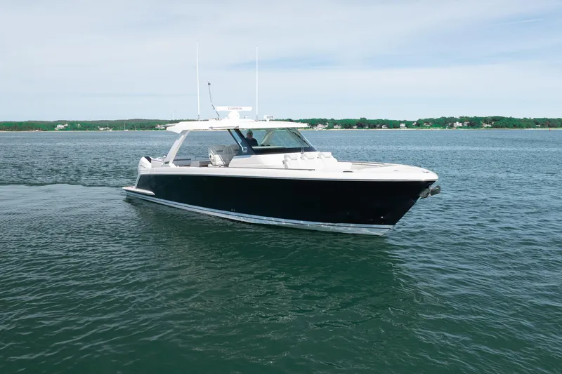 Slide: The Image of 2024 Tiara Yachts 43 LS cruising on calm waters under a clear sky. - 8