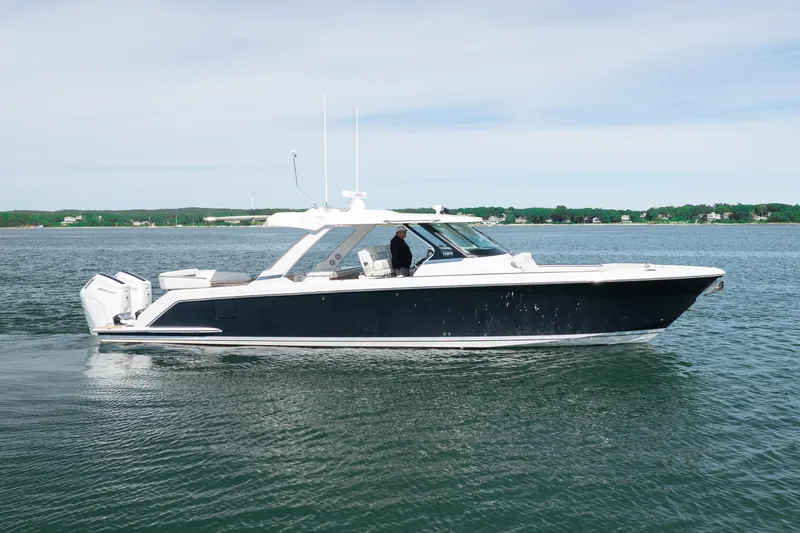 The Image of 2024 Tiara Yachts 43 LS cruising on calm waters, showcasing sleek design and luxury. - 0