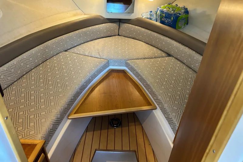 Slide: The Image of Cozy interior of 2017 Cutwater C-24 boat with patterned cushions and wooden accents. - 12