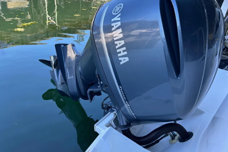 Slide: The Image of Yamaha outboard motor on a 2017 Cutwater C-24 boat, reflecting on calm water. - 18