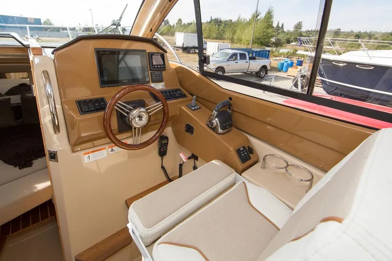 Slide: The Image of Manufacturer Provided Image: Interior helm of a 2017 Cutwater C-24 boat with steering wheel and navigation controls. - 7