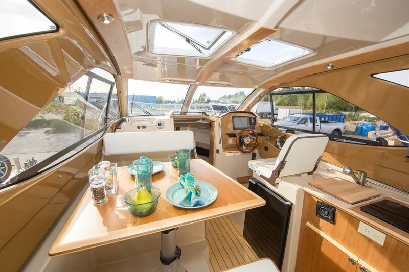 Slide: The Image of Manufacturer Provided Image: Interior of 2017 Cutwater C-24 boat with dining table and helm station. - 9