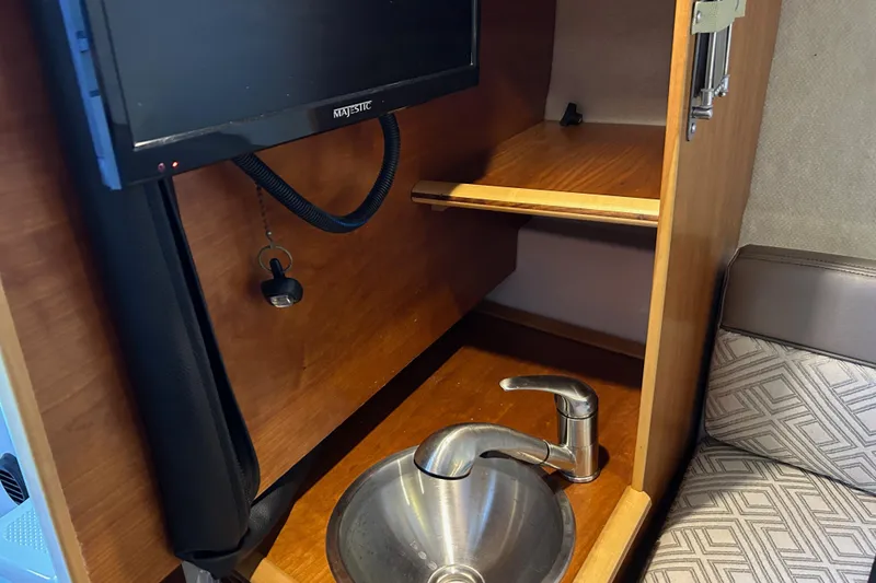 Slide: The Image of Interior of 2017 Cutwater C-24 boat with sink, faucet, and mounted TV. - 17