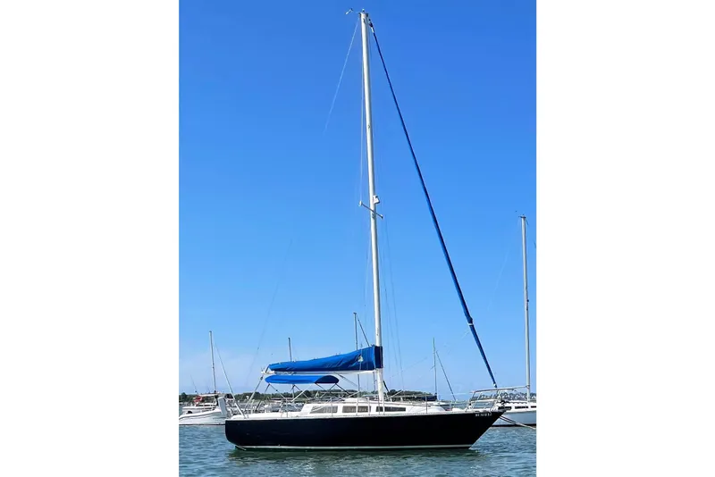 The Image of 1981 S2 9.2A sailboat with blue sail cover on calm water. - 0