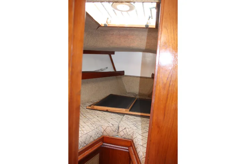Slide: The Image of Interior cabin of a 1981 S2 9.2A sailboat with wooden trim and cozy sleeping area. - 16